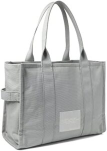 Here is your SEO meta description:

"Elevate your style with the Marc Jacobs The Large Tote Bag, featuring spacious interior, durable construction and sleek design. Perfect for daily use or travel, get ready to carry all your essentials in style."